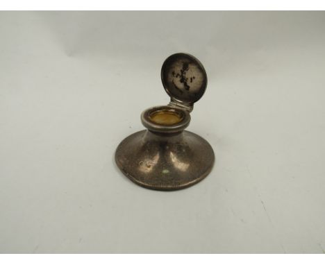 A silver capstan inkwell
