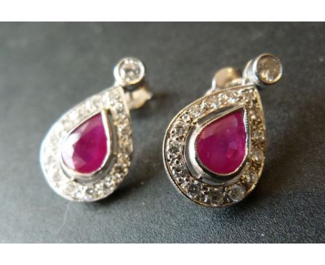 A Pair of White Gold Ruby and Diamond Drop Ear Studs each with a teardrop ruby surrounded by diamonds