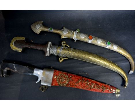 A Persian Jambiya, with engraved scabbard together with two other similar Eastern Jambiya