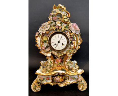 A 19th Century French Porcelain Table Clock by Jacob Petit, the foliate encrusted case with a central hand painted reserve de