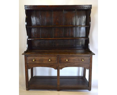 A George III Oak Dresser, the boarded shelf back above two drawers and a pot board flanked by stiles, 140 cms wide