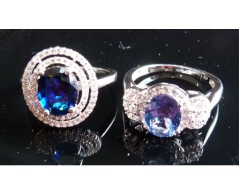 A Silver Dress Ring, set with cubic zirconias and with large central light blue stone together with another similar set dark 