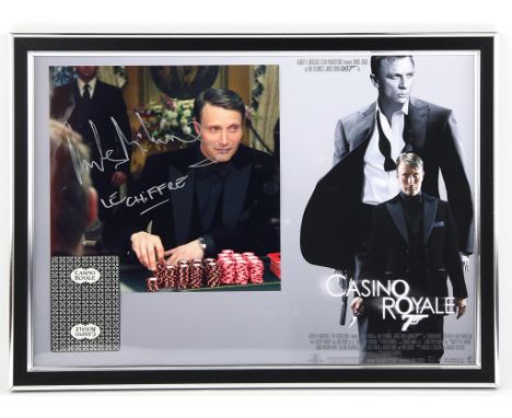 James Bond Casino Royale - 'Casino Royale' playing card and Mads Mikkelsen signed photograph mounted on a mini poster, framed