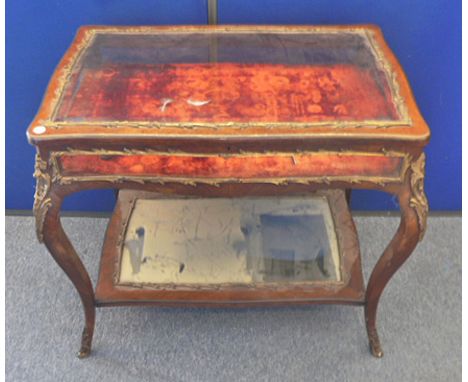 A 19th Century continental kingwood and ormolu mounted bijouterie cabinet, shaped top glazed to all four sides, united by mir