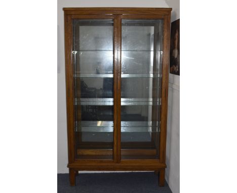 An early 20th Century oak glazed display cabinet by The Lantern Galleries, Leicester Road, Loughborough with four adjustable 