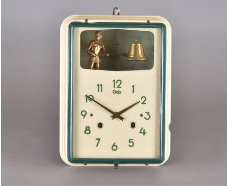 A 20th Century cream plastic automaton wall clock by Odo, green Roman numerals, brass hands, automaton of a man hammering a b