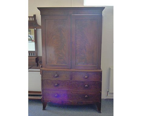 A Victorian mahogany linen press, two panel doors over two short and three long drawers, interior with slides, bracket feet, 