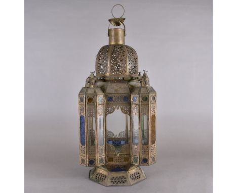 A Moroccan metal and coloured glass ceiling lantern, octagonal form, four oriel windows, octagonal base, domed top, pierced l