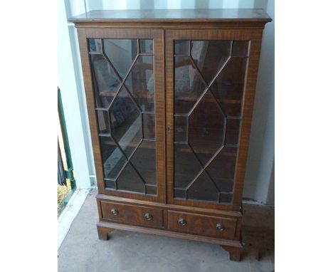 A Georgian style mahogany two door glazed bookcase, two drawers below, bracket supports, 76 cm wide x 27 cm deep x 122 cm hig