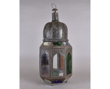 A Moroccan metal and coloured glass ceiling lantern, octagonal form, ogee coloured and colourless glass panels, domed top, pi