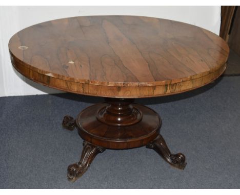 A William IV rosewood tilt-top breakfast table, circular top, single pedestal base, four scroll and bracket feet, 129 cm diam