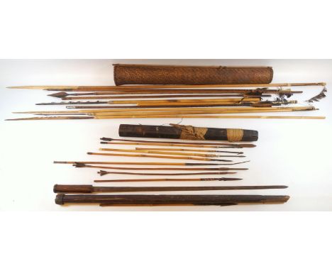 A group of tribal Dayak fish spears and arrows, in  woven basket and bamboo cases and a sword in a hardwood scabbard (20) 