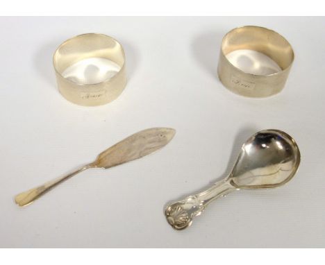 George III silver caddy spoon, hallmarked Birmingham1817, two silver napkin rings, London 1948, a silver butter knife and an 