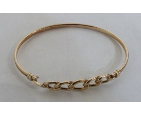 A 9ct articulated bangle. 5.1g. Boxed
