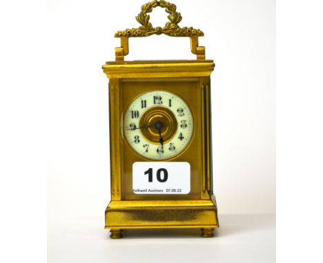 An antique brass French carriage clock with enamelled dial, H. 16cm (appears to be in working order).