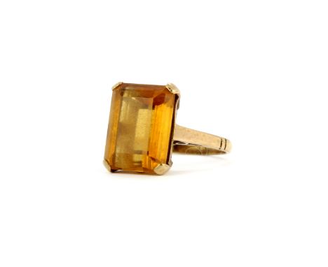 A 9ct yellow gold ring set with a large baguette cut citrine, (K).