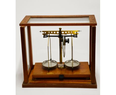 An old cased laboratory balance scale.