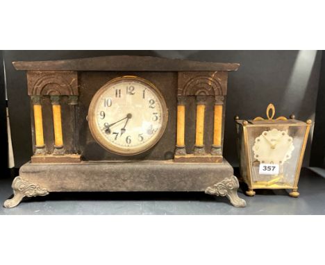 A Koma torsion pendulum mantel clock with a Victorian mantel clock.
