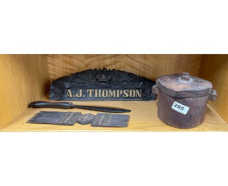 A carved wooden tribal comb and food box with a wooden page turner and carved ebony desk stand.