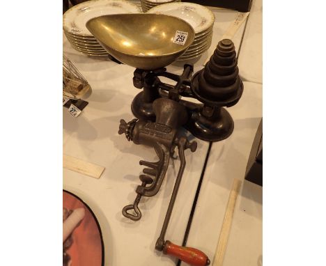 Set of balance scales with weights and a mincer