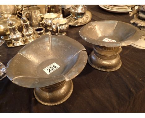 Two pewter candlestick holders and two pewter bowls with floral motif by R Foss