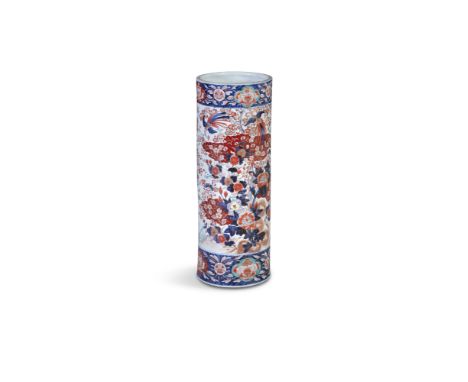 A JAPANESE IMARI PATTERN CYLINDRICAL STICK STAND, decorated with flower blooms and foliage between broad blue ground borders.