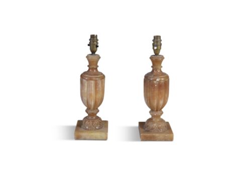 A PAIR OF ALBASTER FLUTED LAMPS, of baluster form, raised on square platform bases. 37cm high to light fitting 