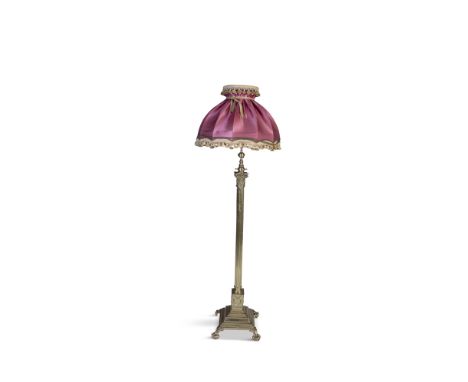 A CAST BRASS STANDARD LAMP, in the form of a Corinthian column raised on a square stepped base and claw and ball feet. 143cm 