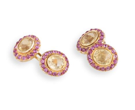 A PAIR OF CITRINE AND RUBY CUFFLINKS, double sided, with cushion-shaped citrine, each within a surround of cabochon rubies, t
