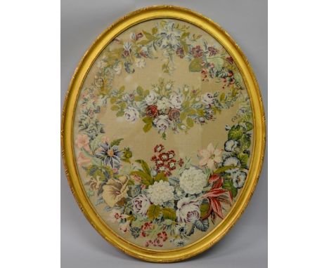 A GOOD 19TH CENTURY BRUSSELS OVAL TAPESTRY PICTURE OF GARLANDS OF FLOWERS in a gilt frame. 23ins x 32ins.