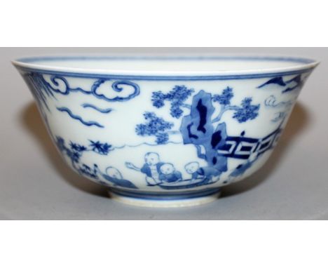 A CHINESE BLUE & WHITE PORCELAIN BOWL, the sides decorated with a continuous scene of boys playing in a fenced garden setting