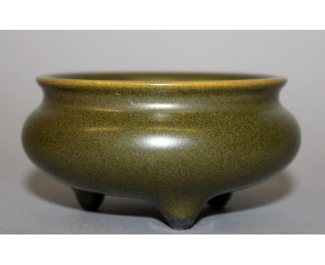 A SMALL CHINESE TEA DUST TRIPOD PORCELAIN CENSER, the base with a Qianlong seal mark, 3.1in diameter & 1.7in high.