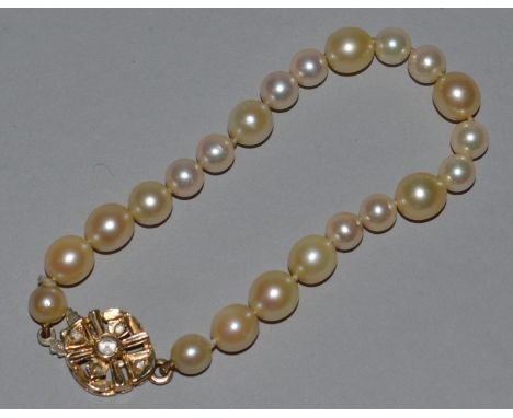 A PEARL BRACELET with gold clasp.