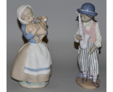 A LLADRO FIGURE, boy with a saxophone, No. 5833, 8.5ins high, and a NAO FIGURE, girl with a lamb, 8.5ins high.