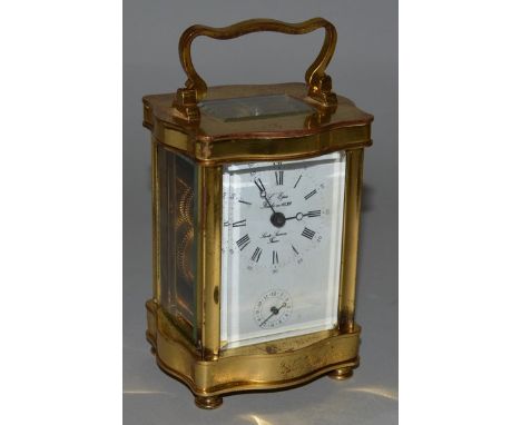 A FRENCH BRASS SERPENTINE FRONTED ALARM AND CARRIAGE CLOCK 4.5ins high.
