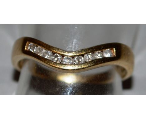 A 9CT GOLD AND DIAMOND WISHBONE RING.