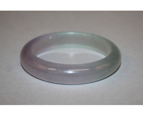 A CHINESE FU LU SHOU THREE COLOUR JADE-LIKE BANGLE, containing shades of lilac, green and white, 3.1in diameter, the inner ri