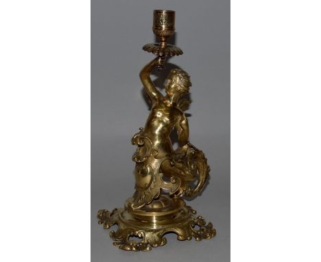 A BRASS LAMP as a cupid holding a candle branch 10ins high.