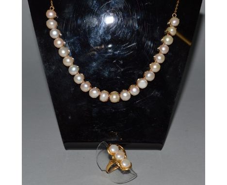 A GOLD MOUNTED PEARL NECKLACE AND MATCHING THREE PEARL RING.