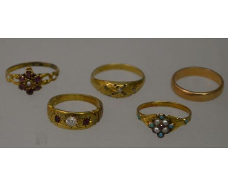 AN 18CT GOLD, DIAMOND AND RUBY GYPSY RING and four other rings.