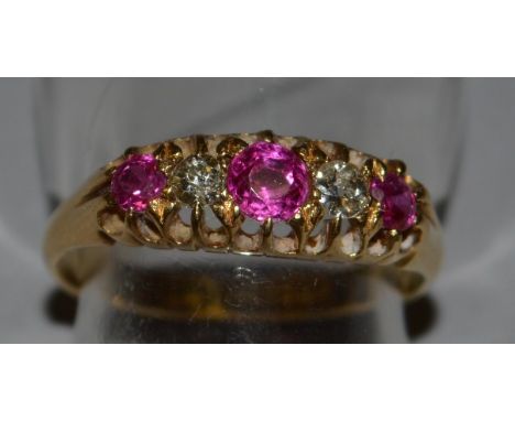 A FIVE STONE RUBY AND DIAMOND RING set in 18ct yellow gold.