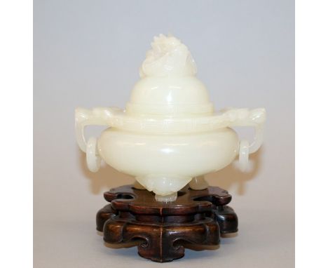 A CHINESE JADE-LIKE TRIPOD CENSER & COVER, together with a fitted wood stand, the sides with double dragon-head and loose rin