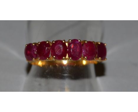 A SIX STONE RUBY RING set in 18ct yellow gold.