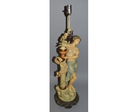 A PAINTED METAL FIGURAL LAMP as a lady standing beside a column. 32ins high.
