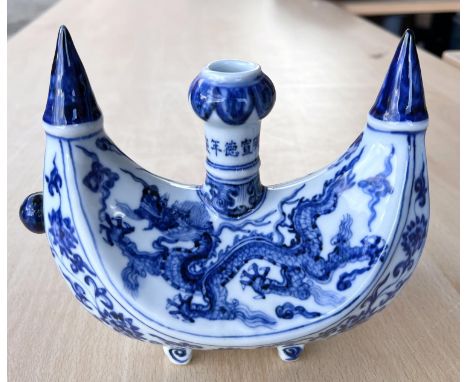 A Chinese blue and white boat shaped 'Pilgrims Flask' decorated with dragon to the body, small bulbous spout to one side, fou