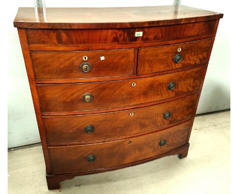 A Georgian figured mahogany bow front chest of 3 long and 2 short drawers with brass ring handles, on bracket feet, width 111