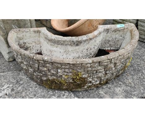 A reconstituted half moon C shaped planter, length 70cm 