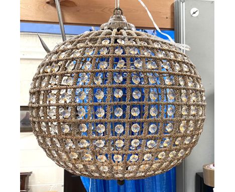 A globe shaped ceiling light fitting aged metal effect with glass pieces between 