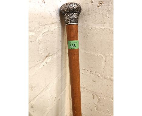 A Victorian walking cane with hallmarked silver embossed top, London 1900 