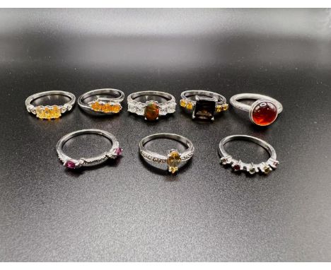 8 silver rings stamped '925' with assorted coloured stones in a variety of settings total weight 